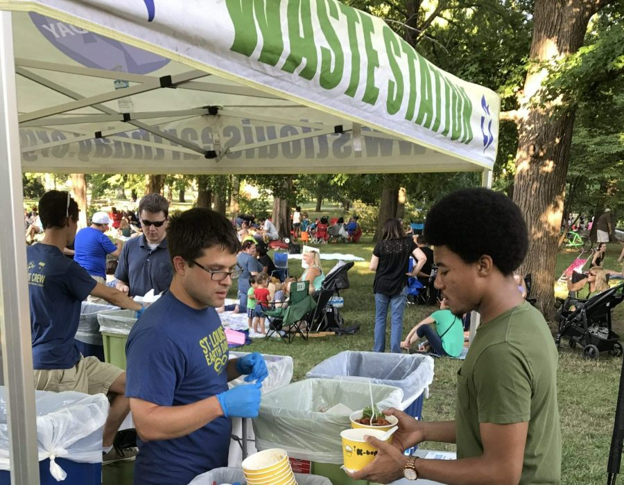 Joe helps an event-goer sort his waste into recycling, compost, and landfill trash.
